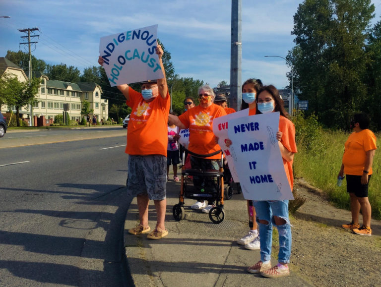 Cowichan Tribes members protest along Highway-1 in response to news that Indignous children were found in unmarked graves in Kamloops