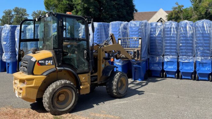 Rows of automatic collection carts being moved by a forklift